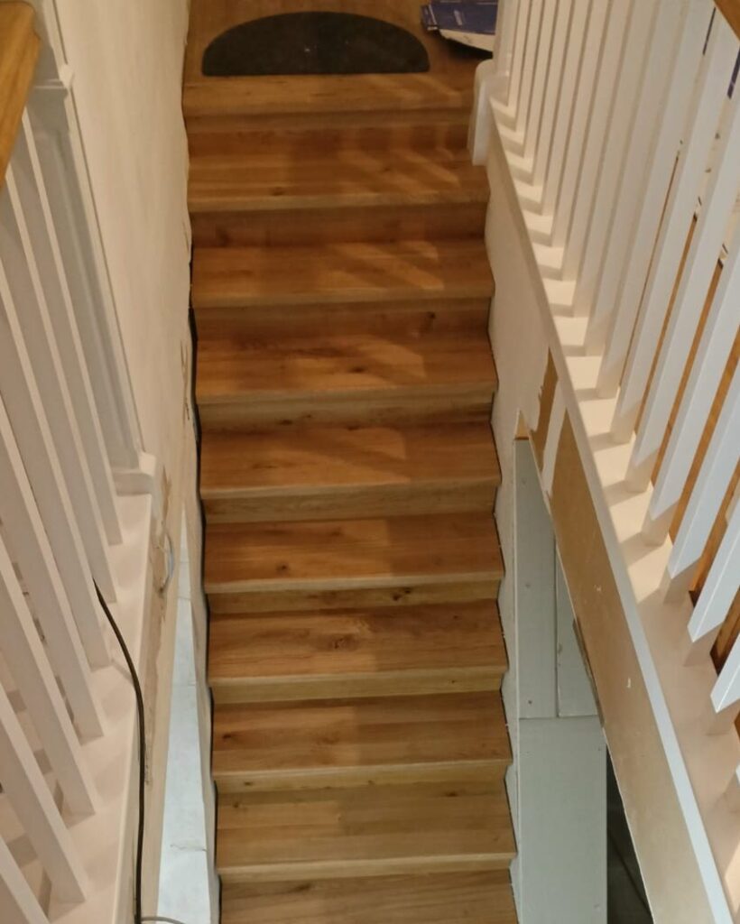 Geschlossene Wangentreppe mit lackierten Holzstufen